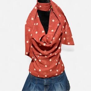 Pink and brown polka dot blouse with cowl neck ruffle detail A very light pink